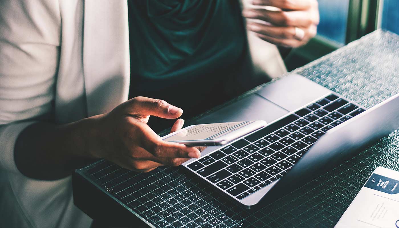 A business woman using a laptop to access online seminars